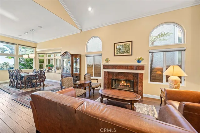a living room with furniture a fireplace and a large window