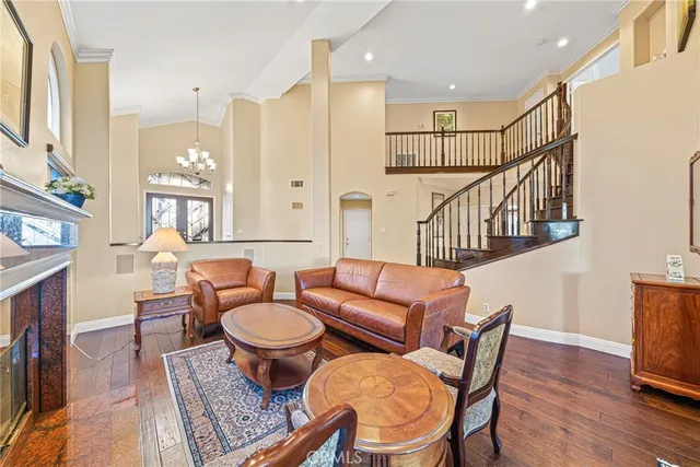 a living room with fireplace furniture and a wooden floor