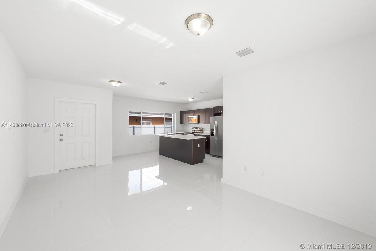 Gladeview Miami, FL 33147 - Photo 2 of 8 a view of a kitchen with a sink and dishwasher a refrigerator with white cabinets