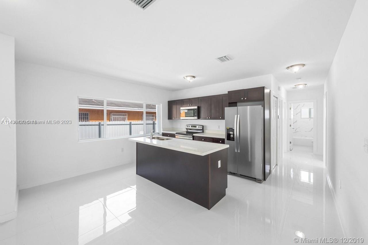 Gladeview Miami, FL 33147 - Photo 3 of 8 a kitchen with stainless steel appliances a refrigerator and a stove top oven