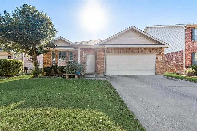 a front view of a house with a garden and plants