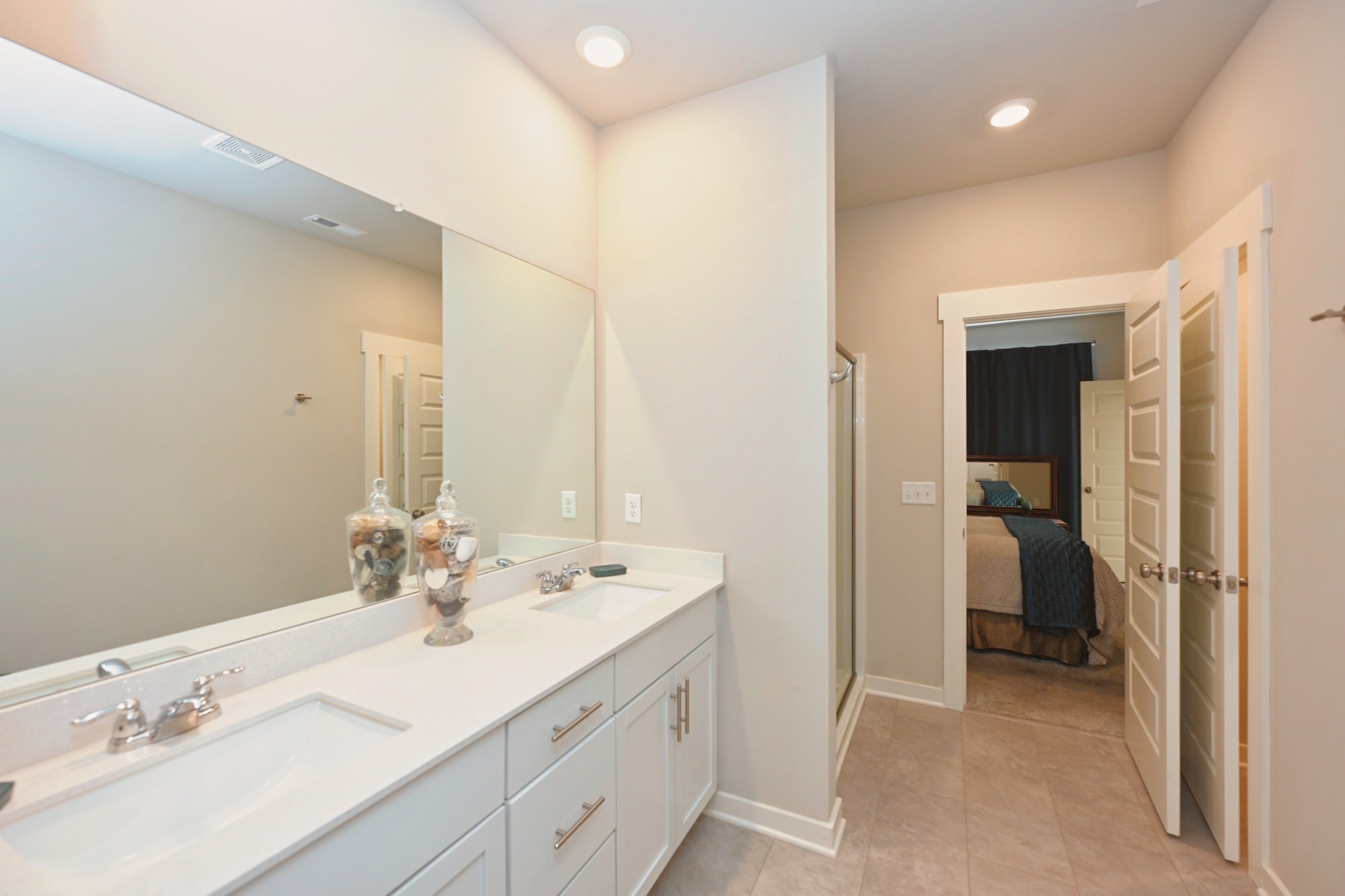 704 Mickelson Way Lebanon, TN 37087 - Photo 19 of 38 a en suite bathroom with a double vanity sink and a mirror