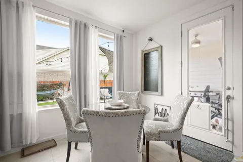 a dining room with furniture and window