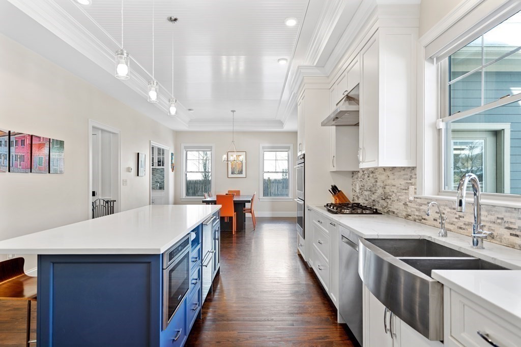 9 Claflin Road Wellesley, MA 02482 - Photo 3 of 31 a large kitchen with stainless steel appliances lots of counter space and wooden floor