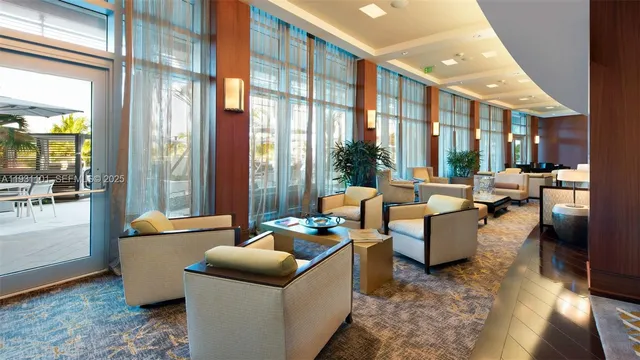 a open kitchen with stainless steel appliances granite countertop a table and chairs