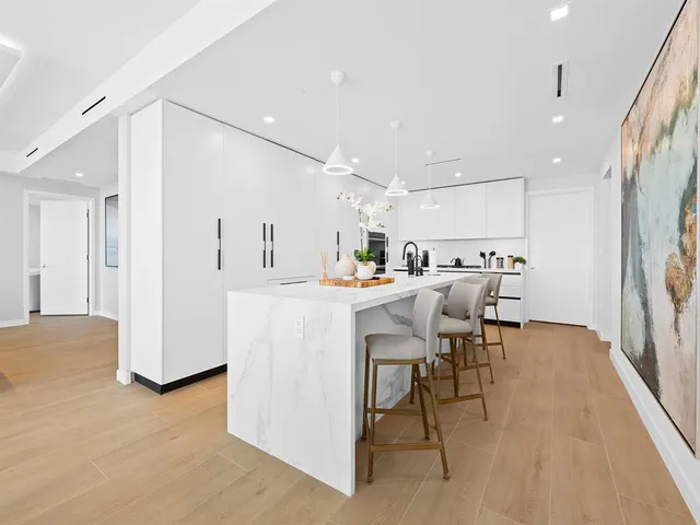 a bathroom with a tub a toilet a sink and mirror