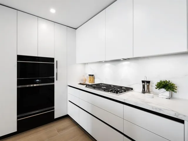 a bathroom with a mirror a sink and a glass door shower