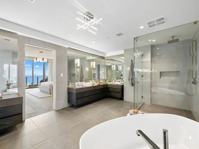 a view of hallway with furniture and wooden floor