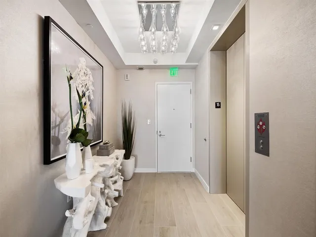 a kitchen with stainless steel appliances kitchen island granite countertop a refrigerator and a dining table