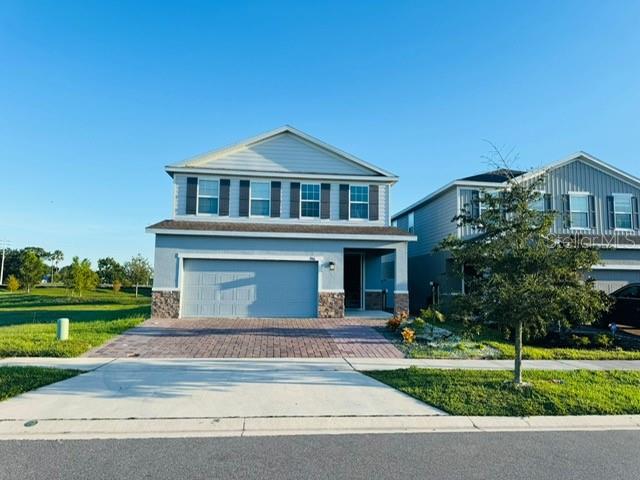 3166 Armstrong Spring Drive Kissimmee, FL 34744 - Photo 1 of 30 a front view of a house with a garden
