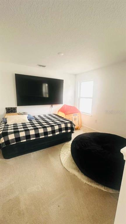 3166 Armstrong Spring Drive Kissimmee, FL 34744 - Photo 15 of 30 a bedroom with a bed and a night stand