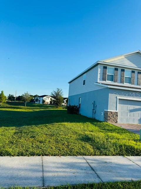 3166 Armstrong Spring Drive Kissimmee, FL 34744 - Photo 2 of 30 a front view of a house with a garden