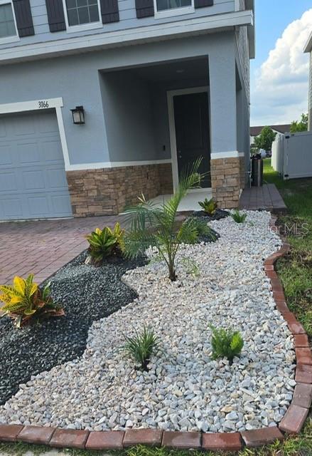 3166 Armstrong Spring Drive Kissimmee, FL 34744 - Photo 3 of 30 a front view of a house with a yard