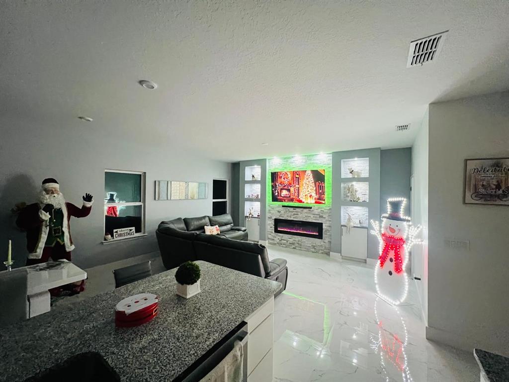 3166 Armstrong Spring Drive Kissimmee, FL 34744 - Photo 6 of 30 a living room with furniture and a flat screen tv