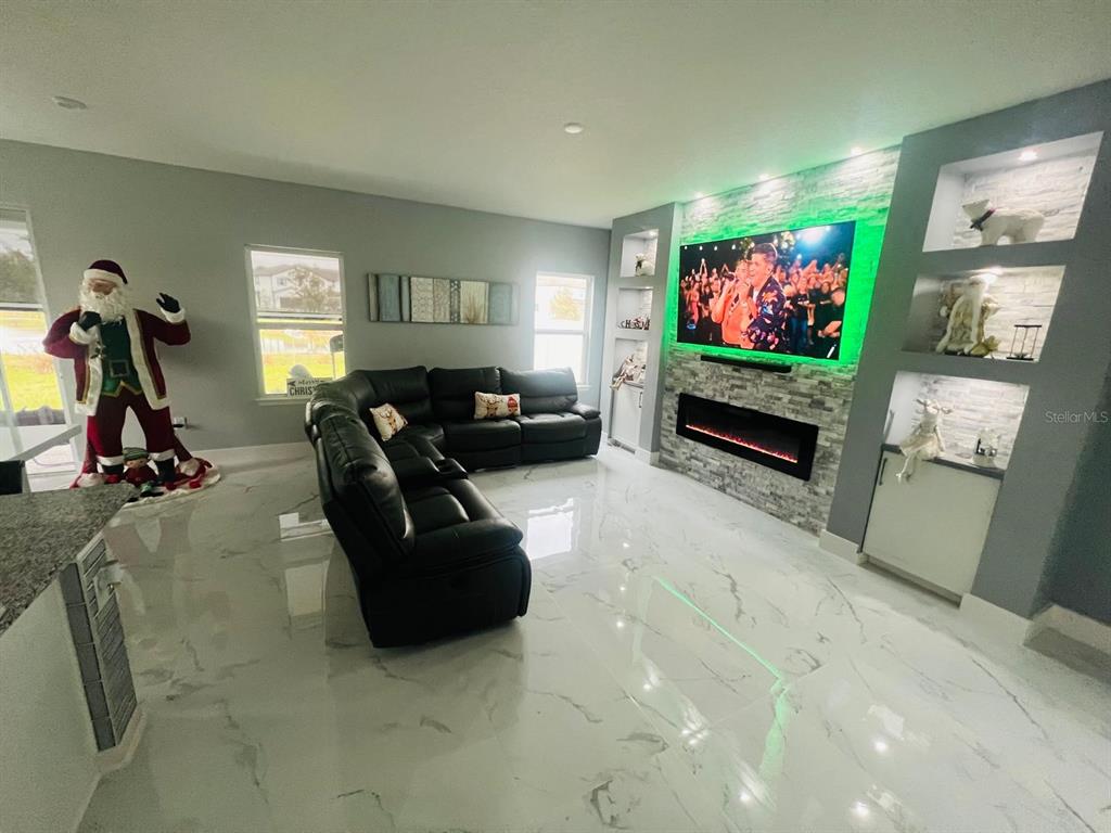 3166 Armstrong Spring Drive Kissimmee, FL 34744 - Photo 7 of 30 a living room with furniture and a flat screen tv