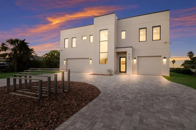 an aerial view of a residential houses with outdoor space
