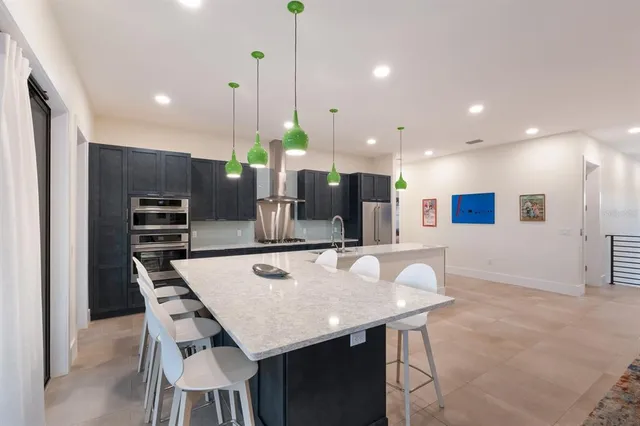 a open kitchen with stainless steel appliances granite countertop a stove and a wooden floors