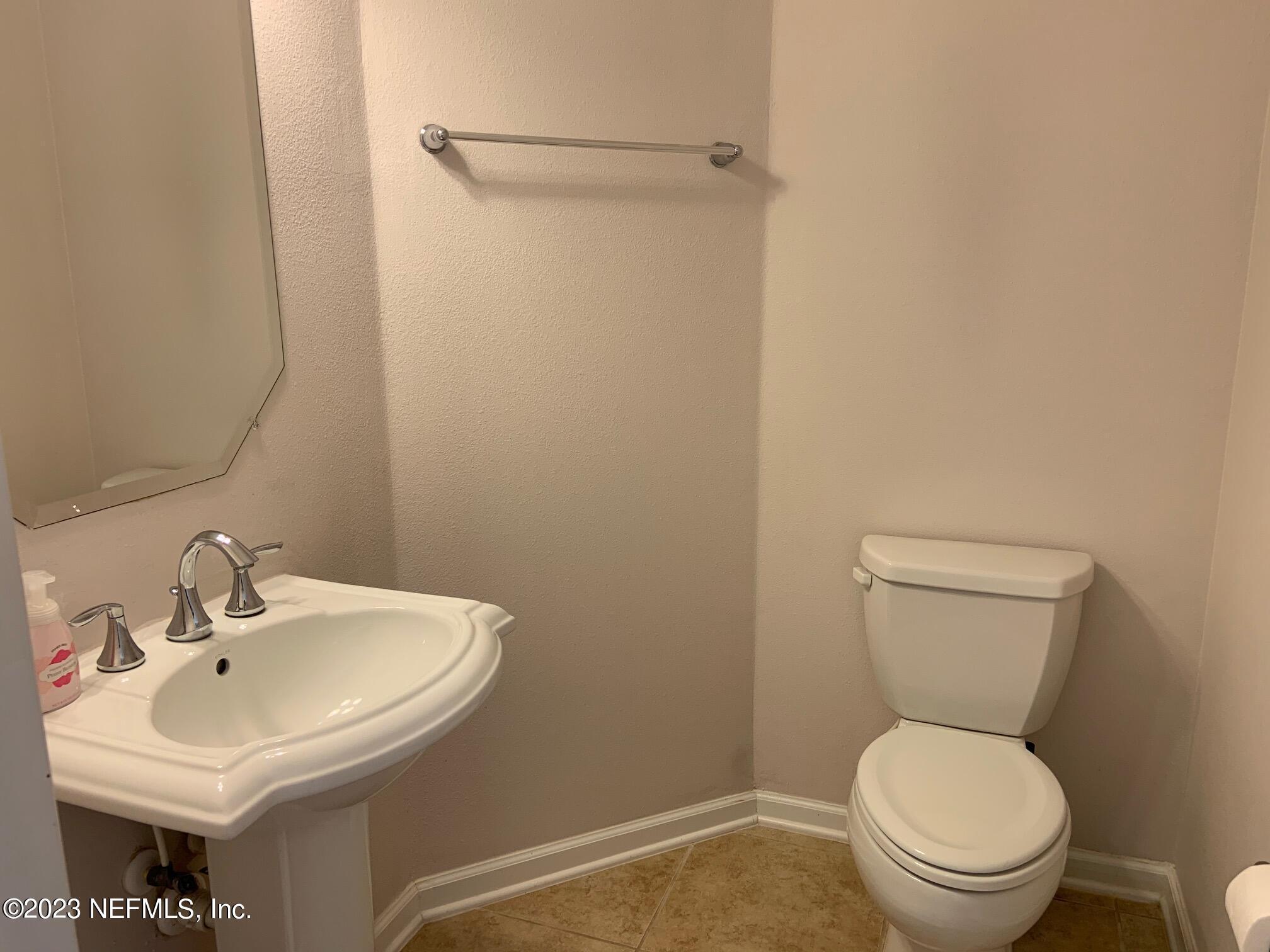 3863 Chasing Falls Road Orange Park, FL 32065 - Photo 13 of 32 a bathroom with a sink a toilet and a mirror