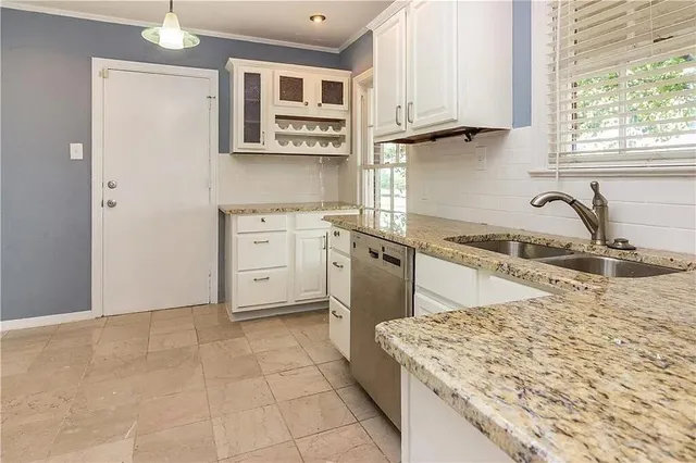 a kitchen with stainless steel appliances granite countertop a sink stove and cabinets