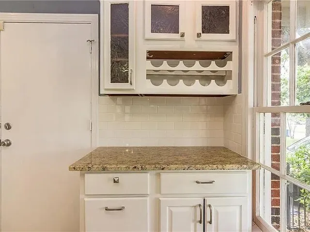 a stove top oven sitting inside of a kitchen