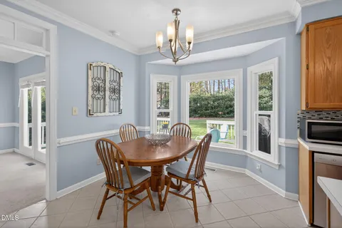 a view of a dining room with furniture wooden floor and chandelier