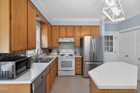a kitchen with a sink a refrigerator and window