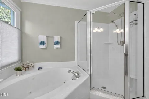 a bathroom with a tub a sink and mirror