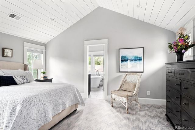 a bedroom with a bed and a potted plant