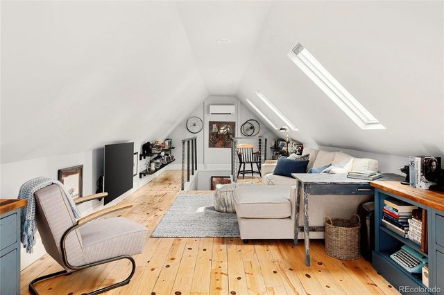 a living room with furniture a flat screen tv and a stove