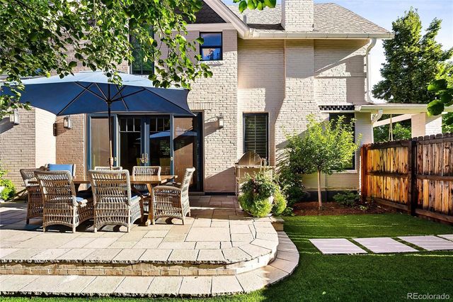 a view of a house with backyard porch and sitting area
