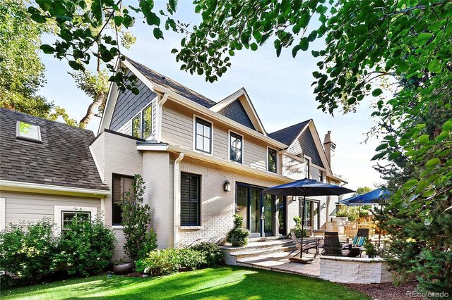 a front view of a house with yard and green space