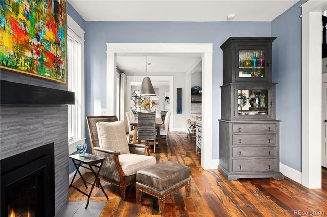 a living room with furniture fireplace and wooden floor