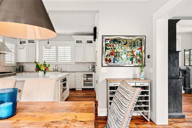 a kitchen with stainless steel appliances kitchen island granite countertop a refrigerator a stove top oven a sink and dishwasher