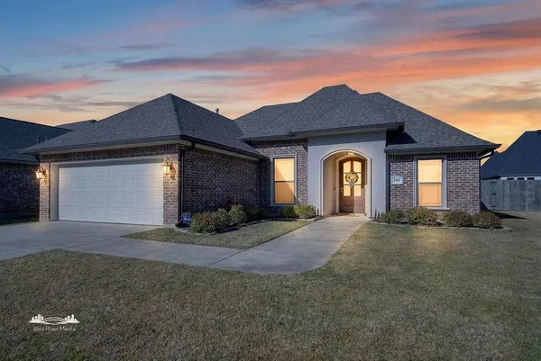 a view of a house with a yard and garage