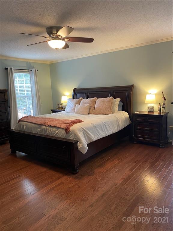 1507 Melchor Road Albemarle, NC 28001 - Photo 2 of 20 a bedroom with a bed and a ceiling fan