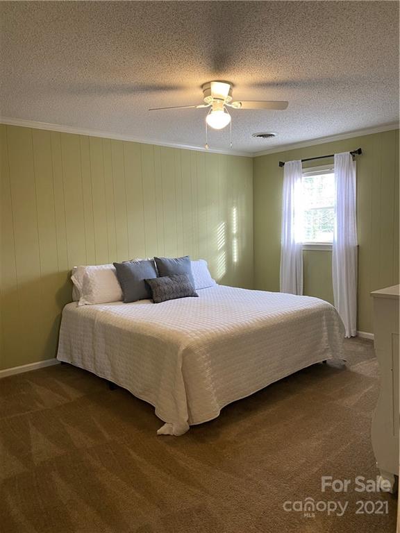 1507 Melchor Road Albemarle, NC 28001 - Photo 13 of 20 a bedroom with a bed and a chandelier