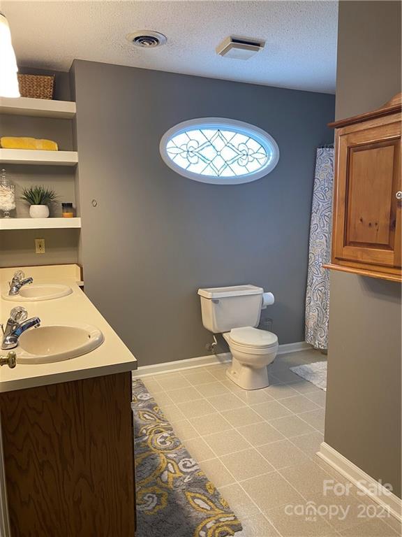 1507 Melchor Road Albemarle, NC 28001 - Photo 15 of 20 a bathroom with a toilet and a sink