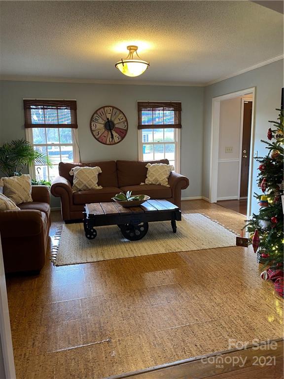 1507 Melchor Road Albemarle, NC 28001 - Photo 9 of 20 a living room with furniture a window and a clock