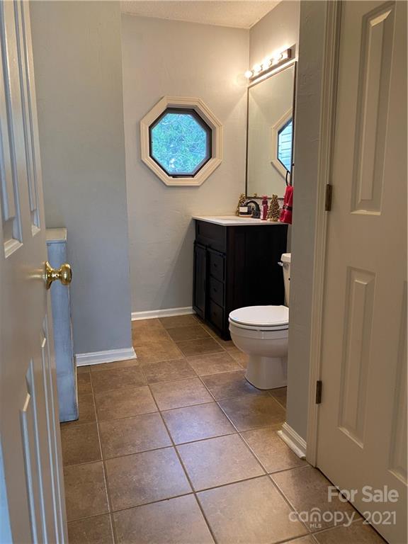 1507 Melchor Road Albemarle, NC 28001 - Photo 10 of 20 a bathroom with a toilet a sink and mirror