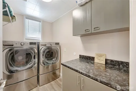 a utility room with sink dryer and washer