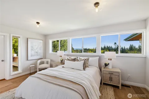 a bedroom with a bed and a large window