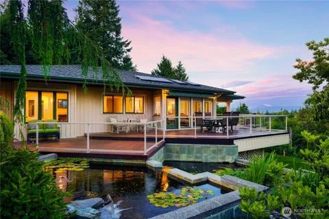 a view of a house with swimming pool and sitting area