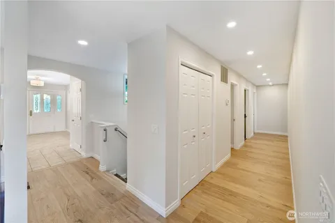a view of a hallway with wooden floor