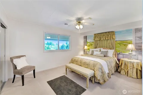 a bed room with a bed and a chair