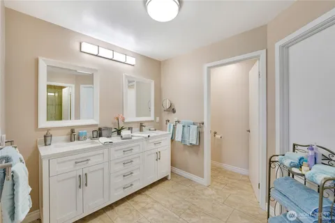 a bathroom with a double vanity sink mirror and double