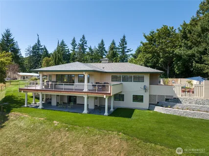 a aerial view of a house with a yard table and chairs