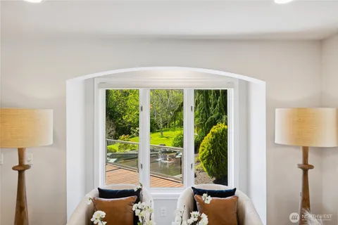 a view of a room that has a window and a table in it