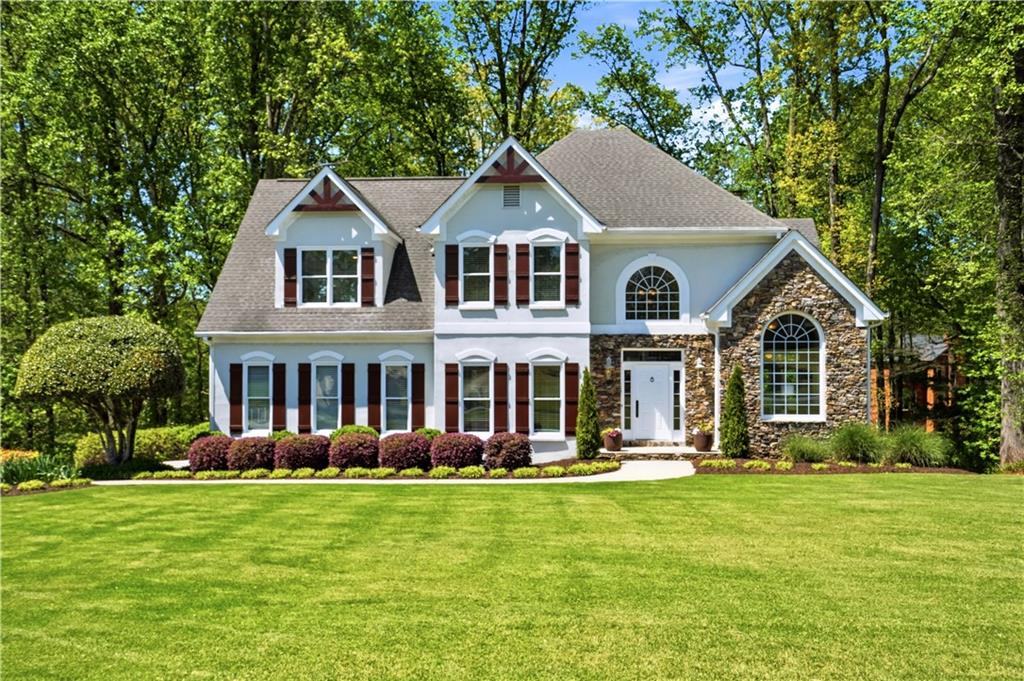 3660 Chartwell Drive Suwanee, GA 30024 - Photo 1 of 50 a front view of a house with a yard