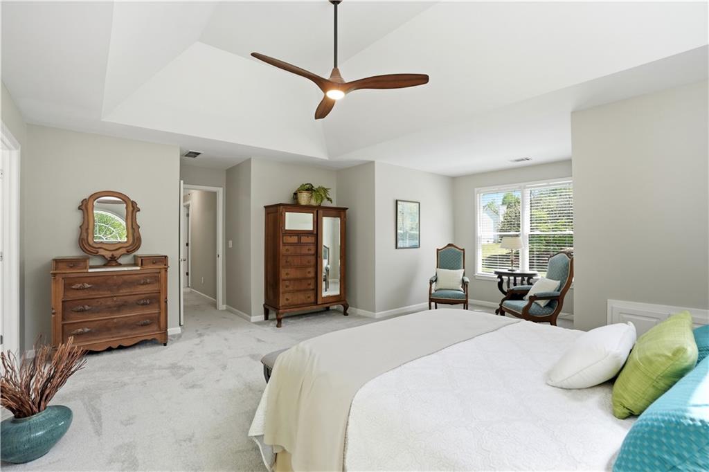 3660 Chartwell Drive Suwanee, GA 30024 - Photo 16 of 50 a bedroom with a bed and ceiling fan