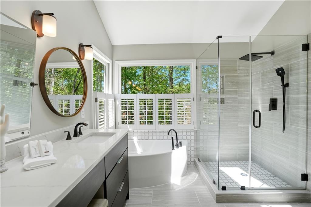 3660 Chartwell Drive Suwanee, GA 30024 - Photo 19 of 50 a bathroom with a tub sink and mirror